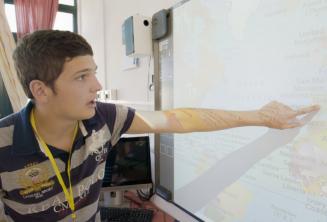 A student pointing to a map in class